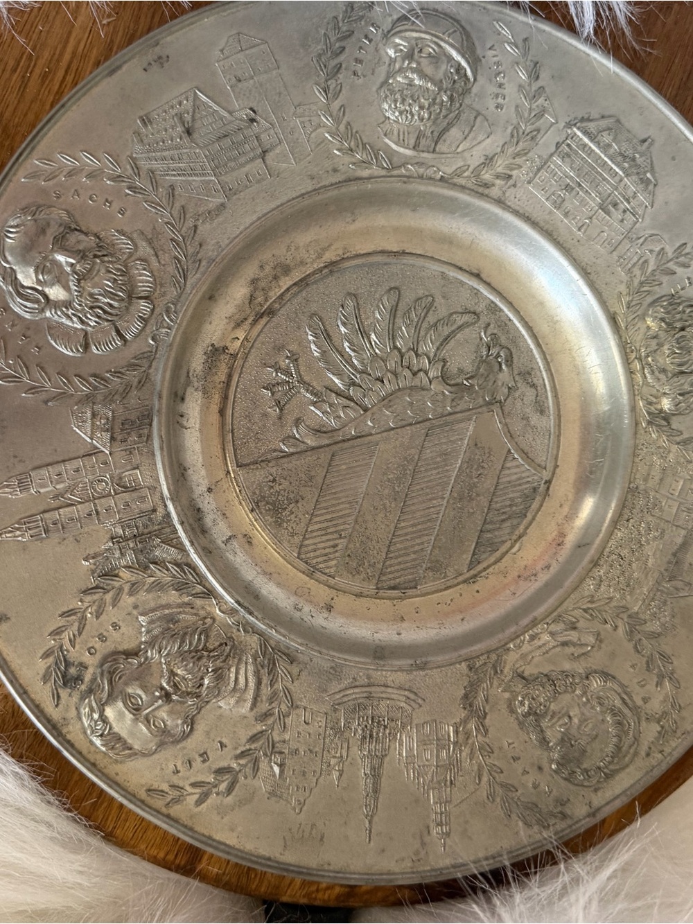 Vintage German pewter wall plate with embossed heraldic coat of arms.